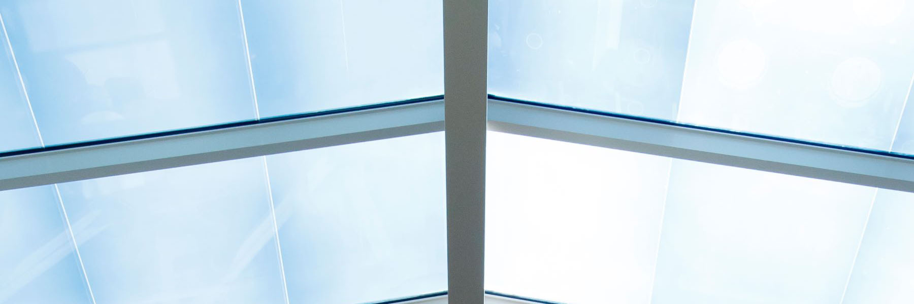 Glass ceiling with the sun shining through.