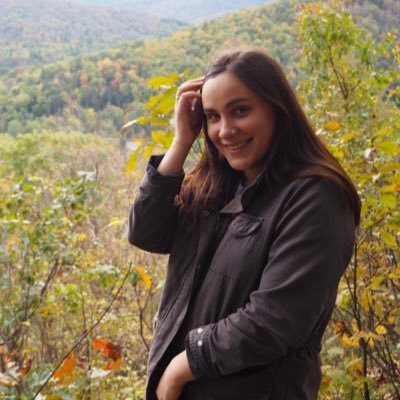 Anna Hyzy posing in front of trees