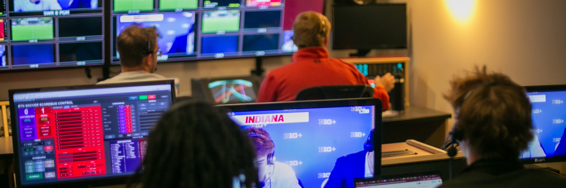 People work on desktops.